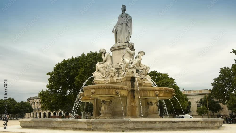 NIMES, FRANCE - June 01, 2016 Fountain Pradier and Amphitheatre NIMES, FRANCE - June 01, 2016 Fountain Pradier and Amphitheatre