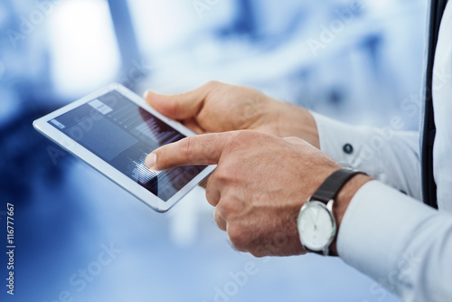 Plakat w ramie Businessman using a digital tablet