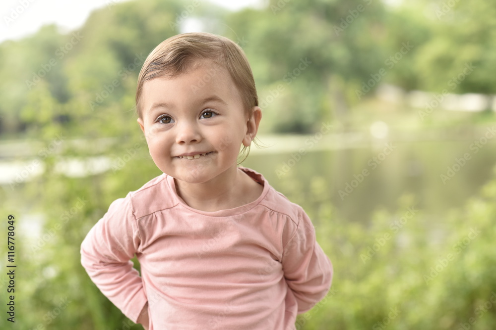Cute 2-year-old girl playing in wild flower field Cute 2-year-old girl playing in wild flower field