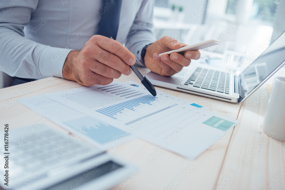 Businessman using a financial app Businessman using a financial app