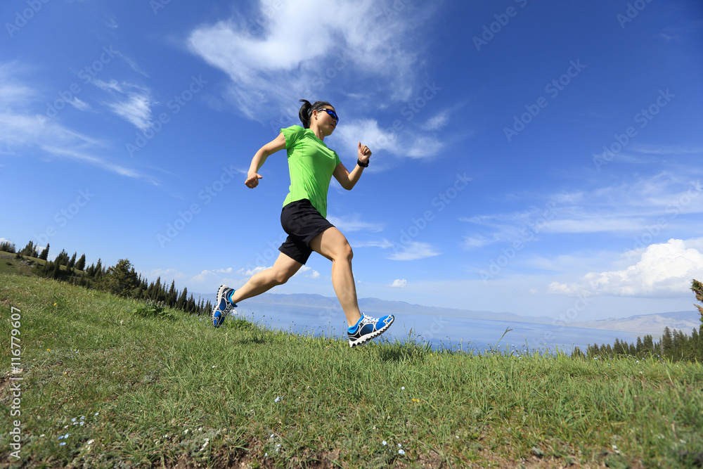healthy young woman trail runner running on beautiful mountain peak healthy young woman trail runner running on beautiful mountain peak