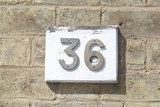 House number 36 sign on wall