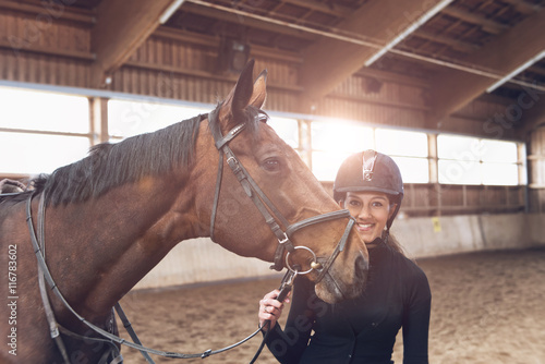 Smiling attractive woman with her horse © XtravaganT