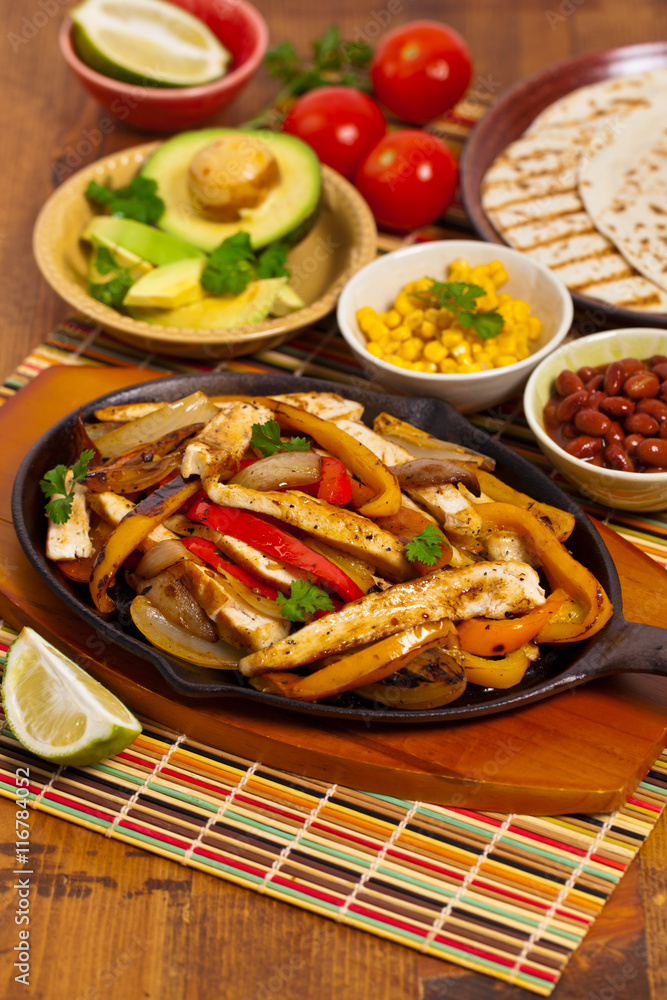 Chicken Fajitas with Grilled Onions and Bell Peppers. Selective focus. Chicken Fajitas with Grilled Onions and Bell Peppers. Selective focus.