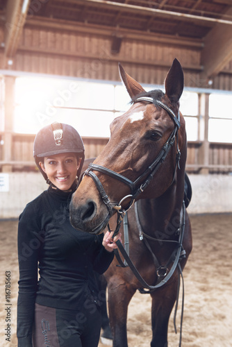 Horse nuzzling a smiling attractive young woman © XtravaganT