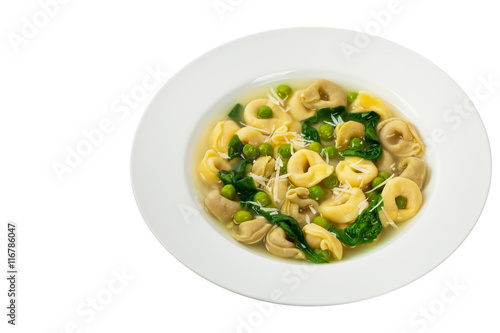 Tortellini Soup with Peas and Spinach Isolated. Selective focus.