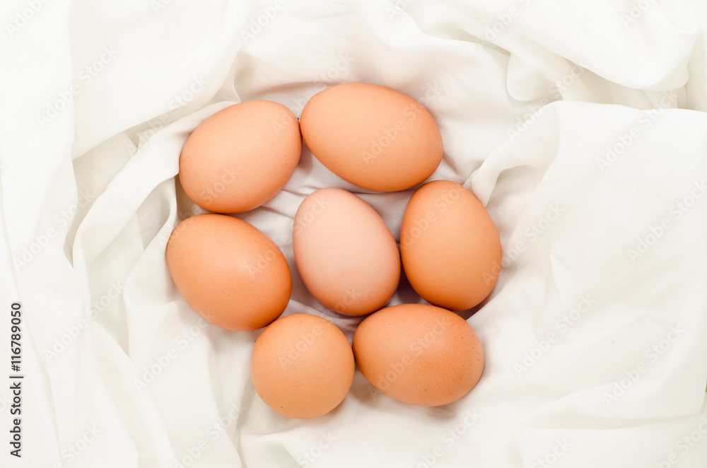 Eggs on fabric White.Chicken eggs on white fabric.easter eggs on fabric with copy space. Eggs on fabric White.Chicken eggs on white fabric.easter eggs on fabric with copy space.