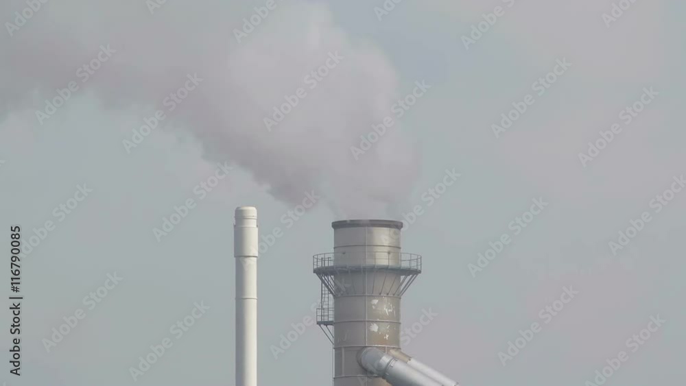 A shot of heavy industry with air pollution. Closeup shot of the factories chimney. A shot of heavy industry with air pollution. Closeup shot of the factories chimney.