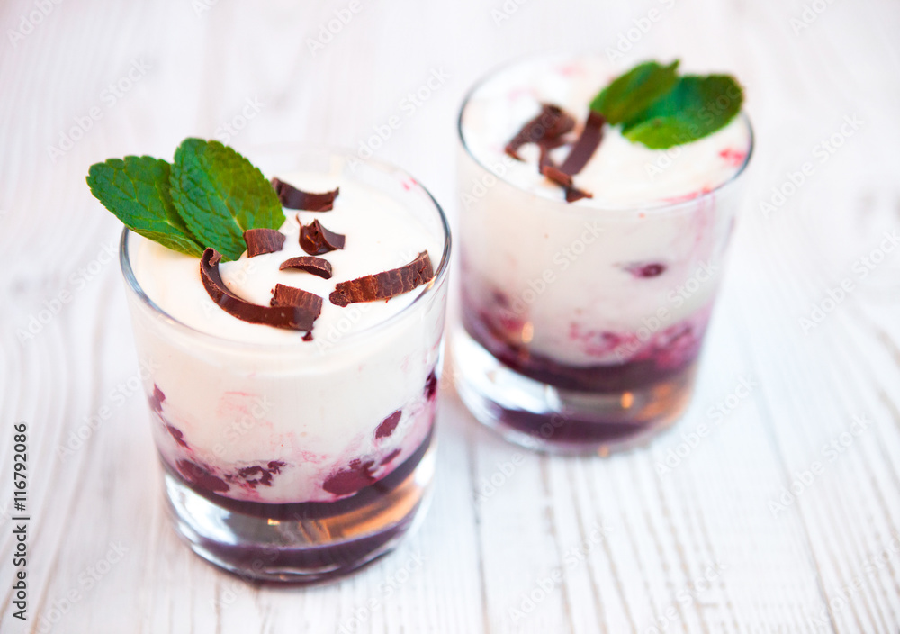tasty dessert with bilberry cream and creamy mousse decorated wi tasty dessert with bilberry cream and creamy mousse decorated wi