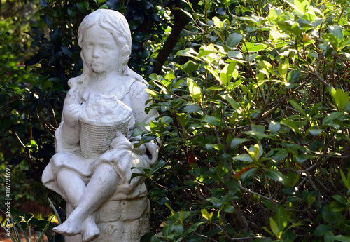 Statue of a little girl in a botanical garden © brucedierenfeld