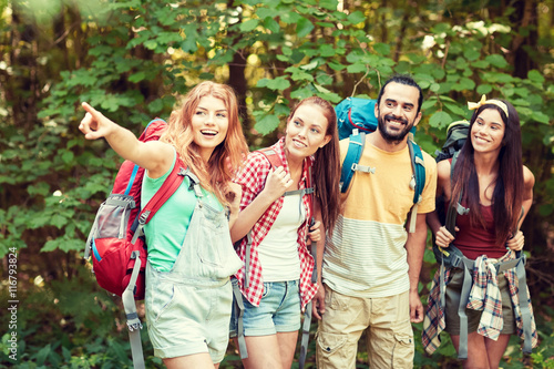 group of smiling friends with backpacks hiking © Syda Productions