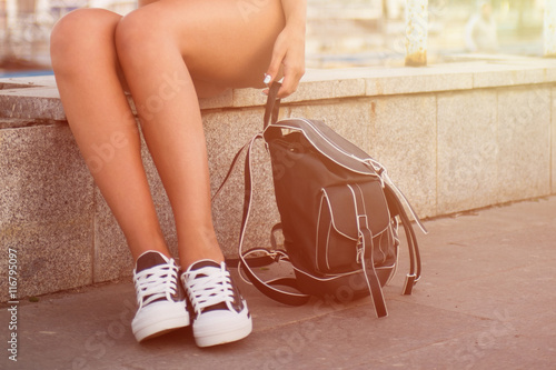 closeup of woman legs in white gumshoes