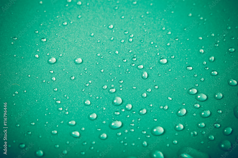 Drops of water on a color background. Green. Shallow depth of fi