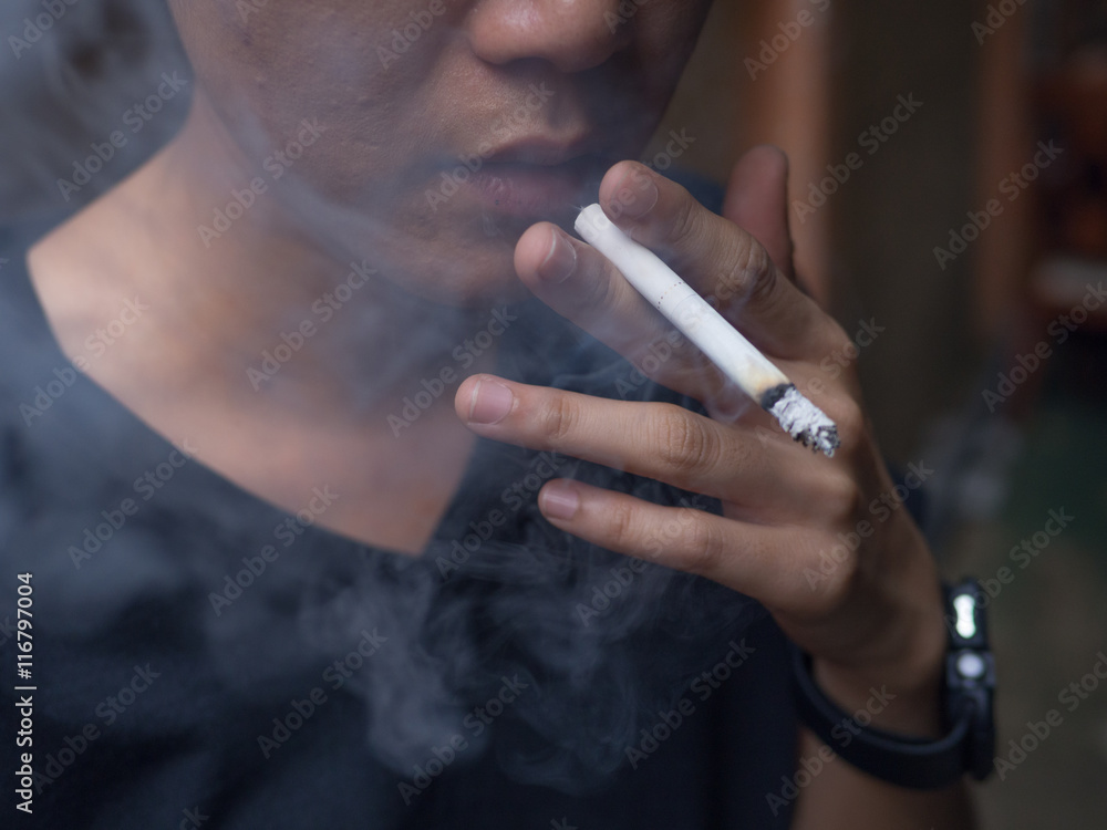 Obraz premium cigarette smoke with lighter and hand