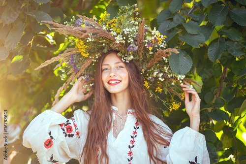 Obraz na plátně Beautiful girl in meadow in national suite