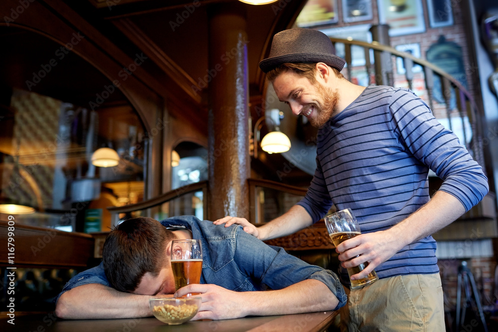 male friends drinking beer at bar or pub male friends drinking beer at bar or pub