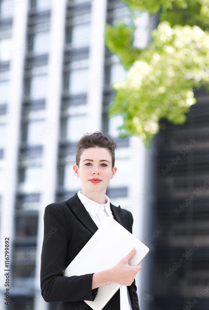 Modern business woman holding laptop