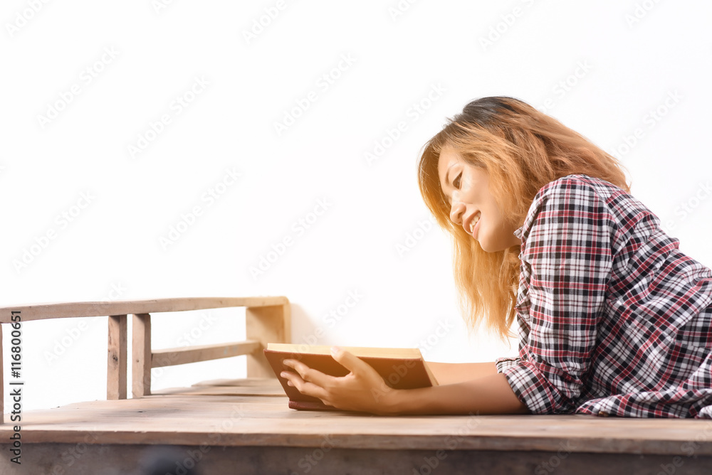 Happy blonde girl sitting and reading a book Stock Photo | Adobe Stock