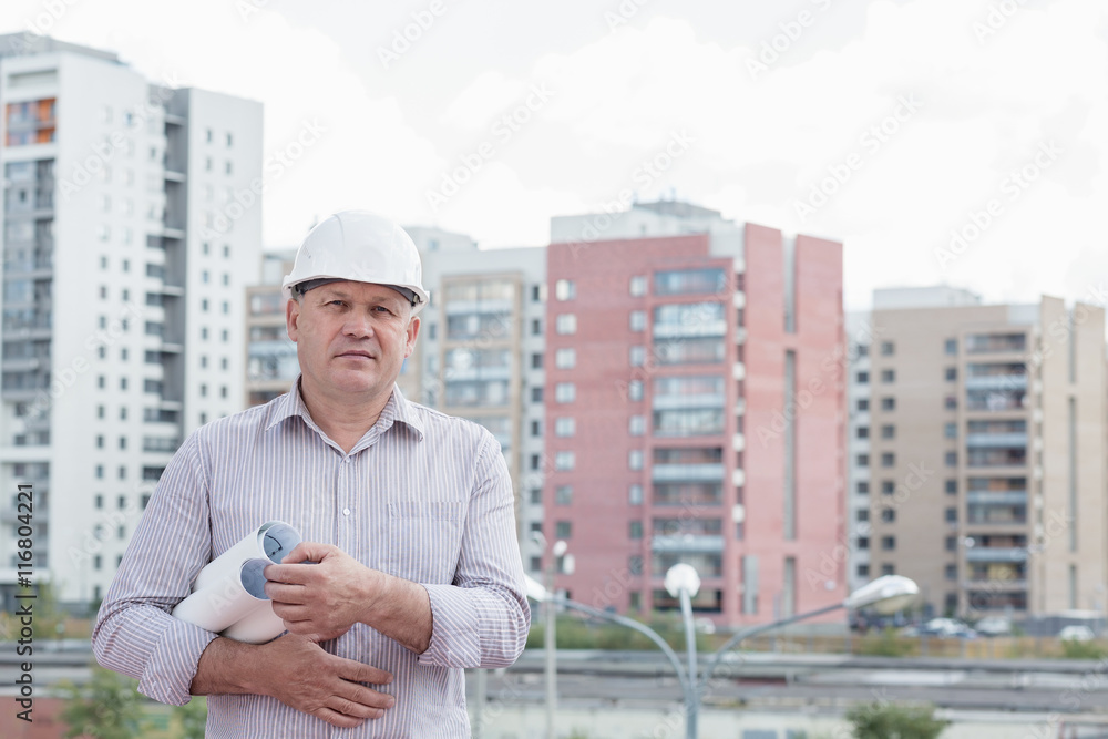 An engineer holding construction plans in hands An engineer holding construction plans in hands