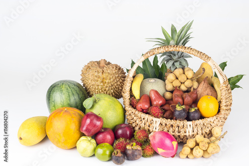 Fototapeta Naklejka Na Ścianę i Meble -  Tropical fruits inside basket with background