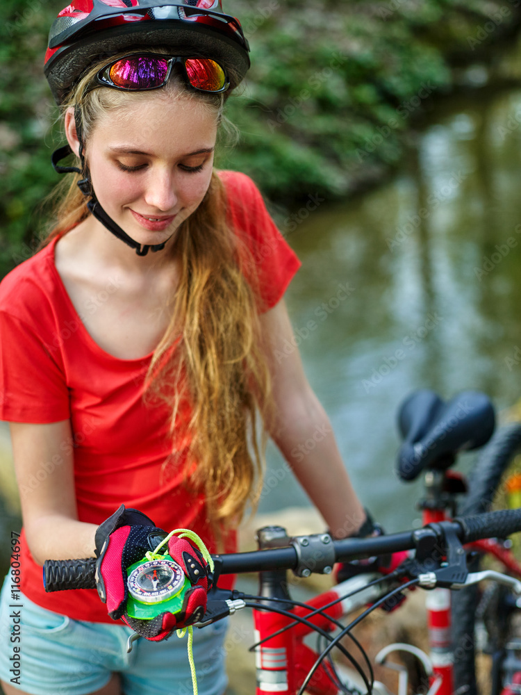 Bicycle girl. Girl rides bicycle. Girl on bicycle look at compass