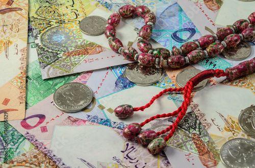 Qatar currency with prayer beads photo