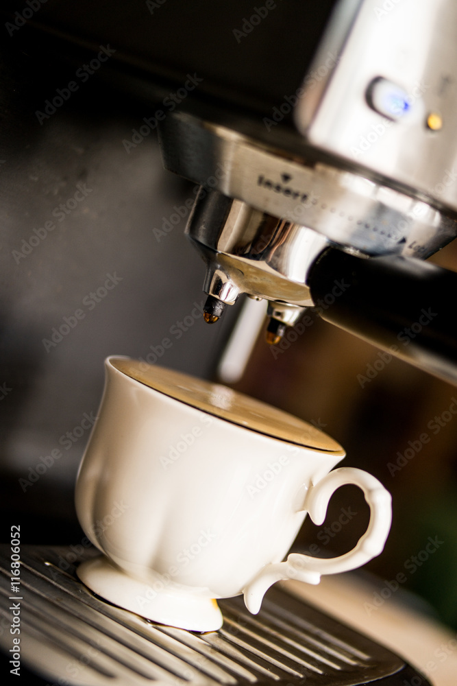 espresso machine making coffee and pouring in a white cup espresso machine making coffee and pouring in a white cup
