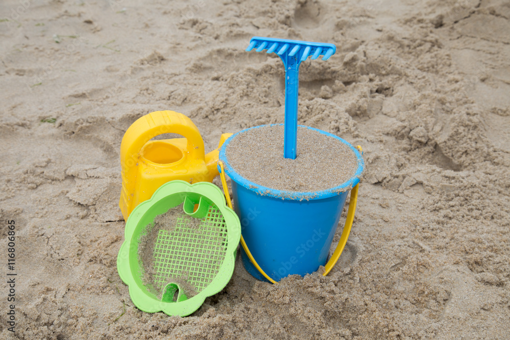 Child's toys on sandy beach, summer holidays concept Child's toys on sandy beach, summer holidays concept