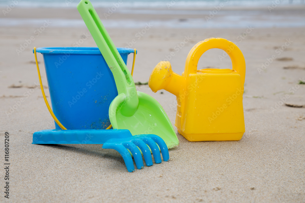 Beach toys in the sand at the beach Beach toys in the sand at the beach