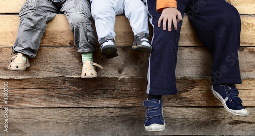 three boy on wood deck