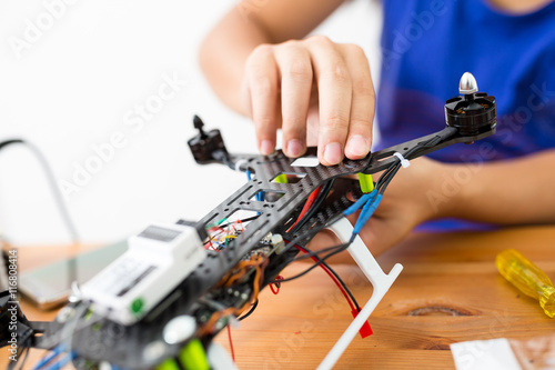 Man connecting the component of the drone