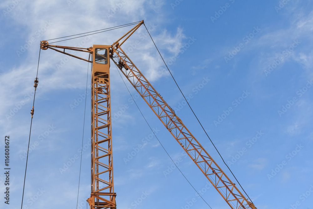 Tower crane against the blue sky. Building Tower crane against the blue sky. Building