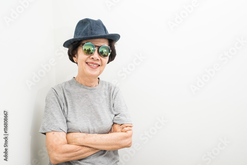 old women wear hat and sunglasses smailling with text space © patpongstock