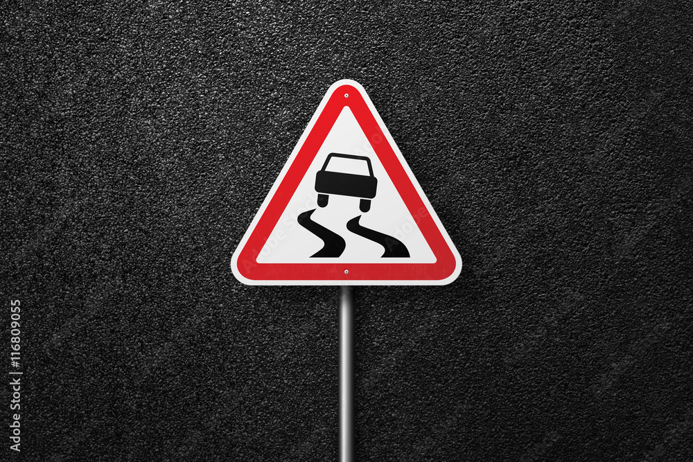Road sign triangular shape with a picture of the car on a background of asphalt. The texture of the tarmac, top view. Road sign triangular shape with a picture of the car on a background of asphalt. The texture of the tarmac, top view.