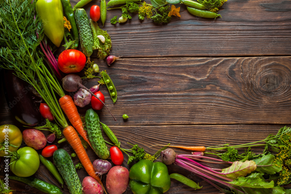 Fresh organic Vegetables on Wooden table with place for text. Healthy Vegetarian food, View from above.