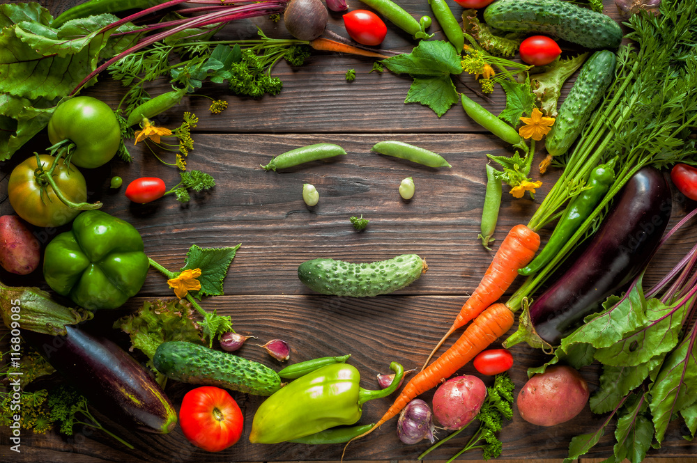 vegetable smiling face. Fresh organic Vegetables on Wooden table. Healthy Vegetarian food, View from above.