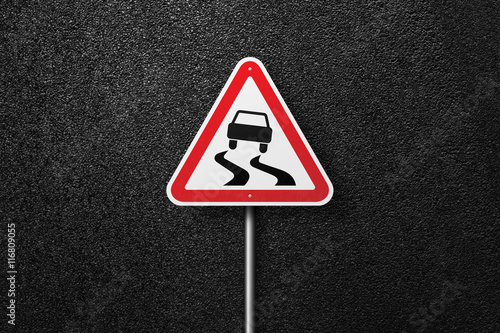 Road sign triangular shape with a picture of the car on a background of asphalt. The texture of the tarmac, top view. © srzaitsev