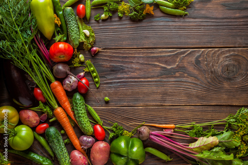 Obraz na płótnie Fresh organic Vegetables on Wooden table with place for text. Healthy Vegetarian food, View from above. w salonie