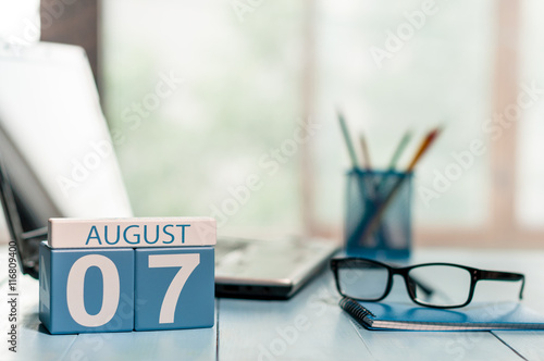 August 7th. Day 7 of month, wooden color calendar on business background. Summer time. Empty space for text photo