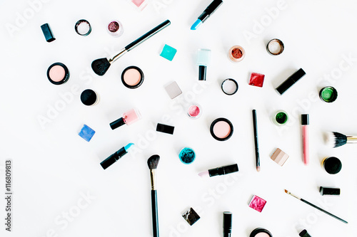 flat lay female cosmetics collage with lipstick, brush on white background. top view set