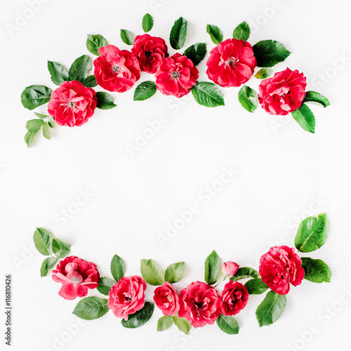 flat lay frame with red roses, branches, leaves and petals isolated on white background. top view