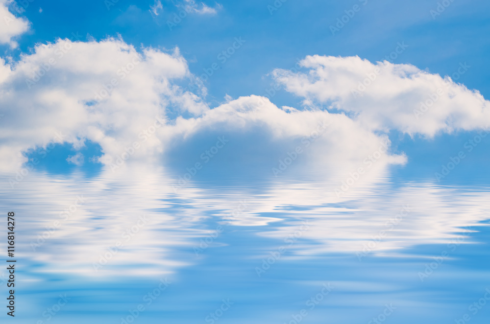 Blue sky with the fluffy white clouds, natural background with copy space and water reflection Blue sky with the fluffy white clouds, natural background with copy space and water reflection