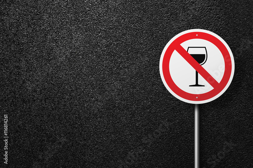 Road sign of the circular shape on a background of asphalt. No alcohol. The texture of the tarmac, top view.