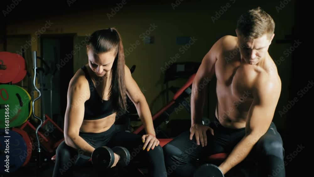 Man and woman working his arms at the gym. Man and woman working his arms at the gym.