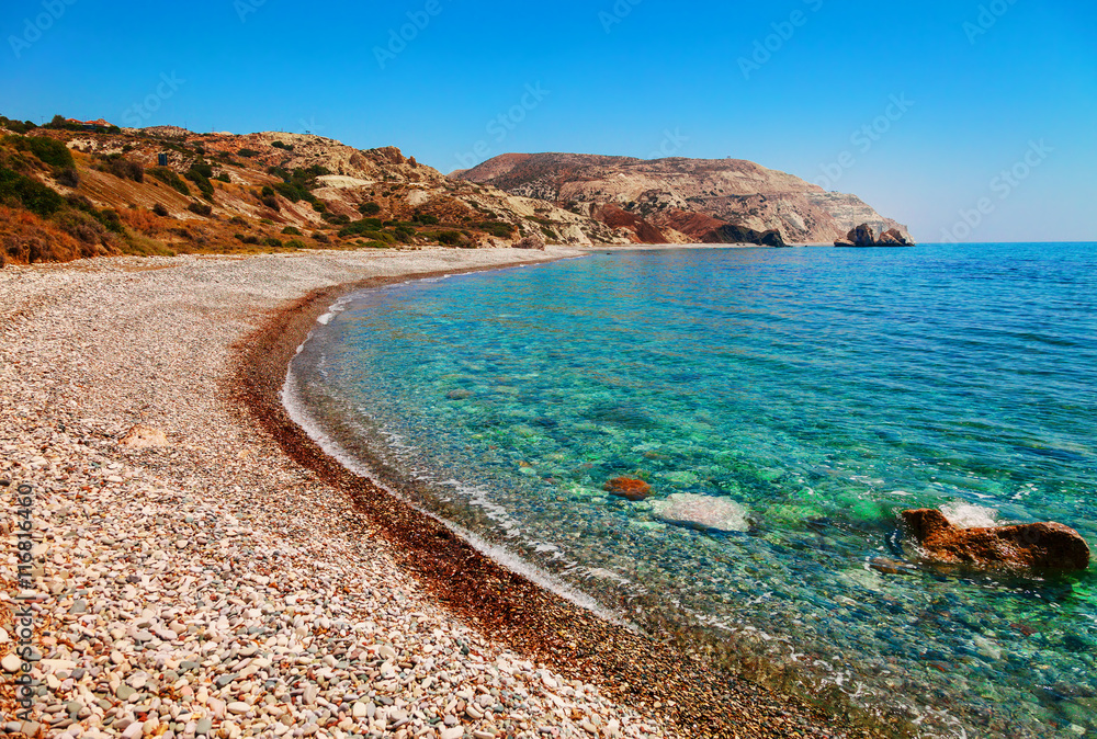 Beautiful beach on Petra tou Romiou (The rock of the Greek), Aphrodite's legendary birthplace in Paphos, Cyprus island, Mediterranean Sea. Amazing blue green sea and sunny day.