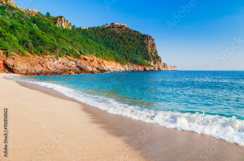 Cleopatra beach with beautiful sand and green rocks in Alanya peninsula, Antalya district, Turkey, Asia. Famous tourist destination with high cliff and ancient old Castle. Summer bright day © oleg_p_100