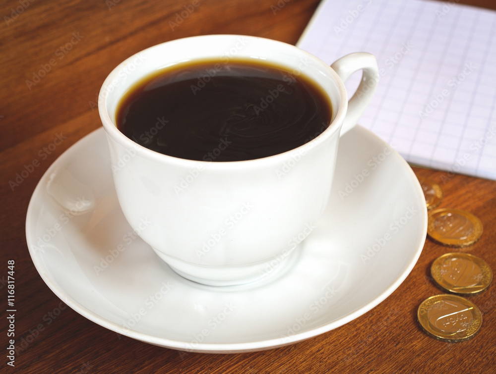 Coffee cup and saucer on a wooden table. Dark background.