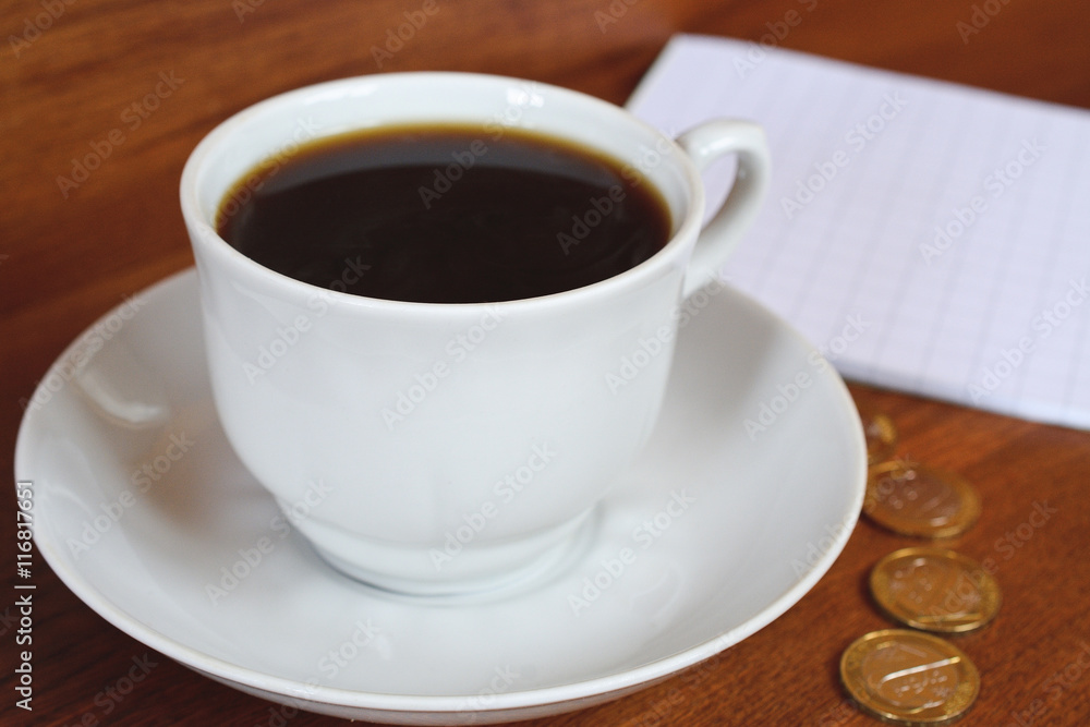 Coffee cup and saucer on a wooden table.