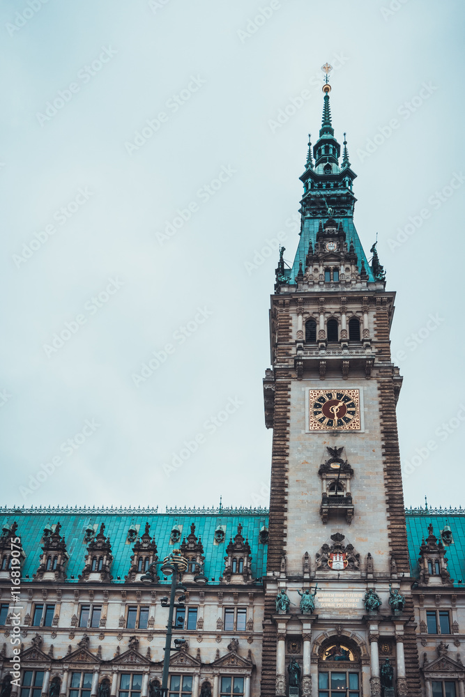 Tall European clock tower with copper roof