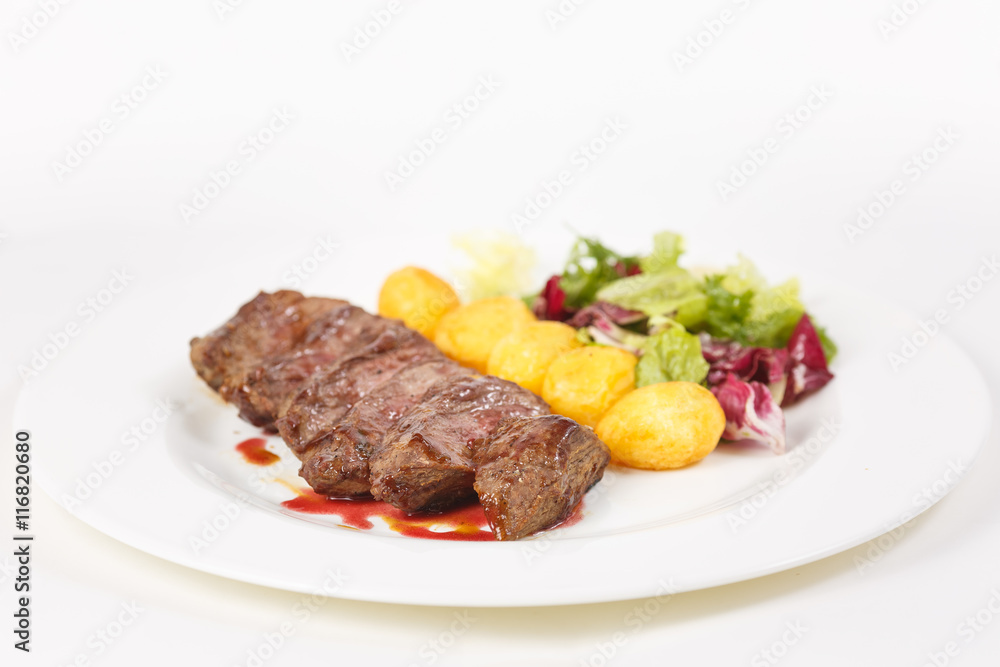 Roasted meat with vegetables on the table Roasted meat with vegetables on the table